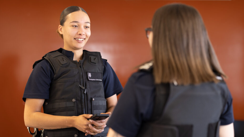 Two female Immigration Officers talking
