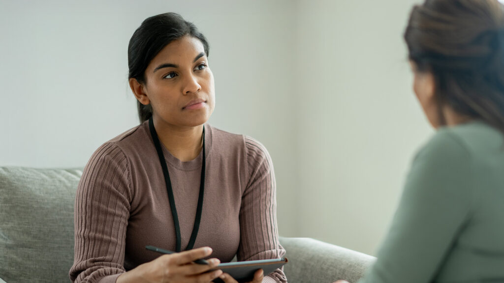 Female caseworker sat talking to a female