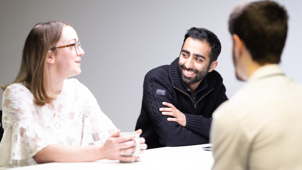 Three members of staff around an office table
