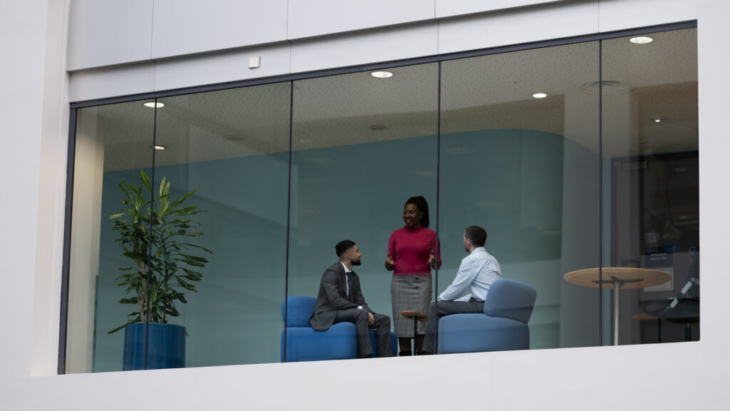 three members of staff in a meeting room
