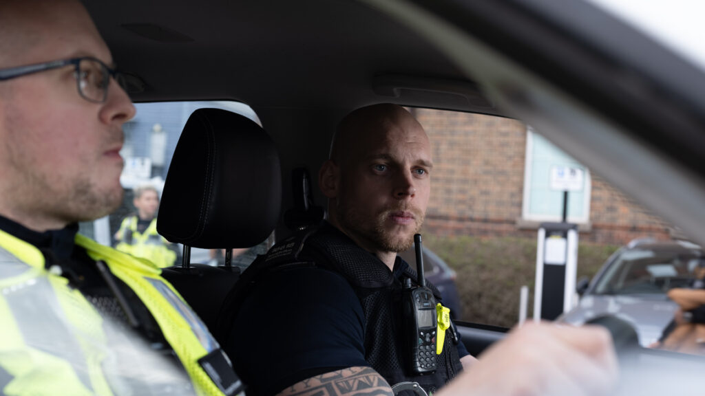 Two uniformed Officers in a vehicle 