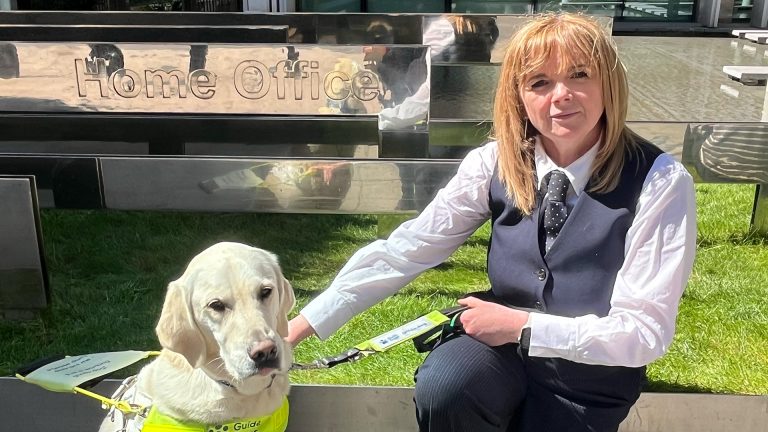 Profile shot of Nikki the guide dog with owner, Jo-Ann.